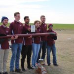 Students posing with rocket