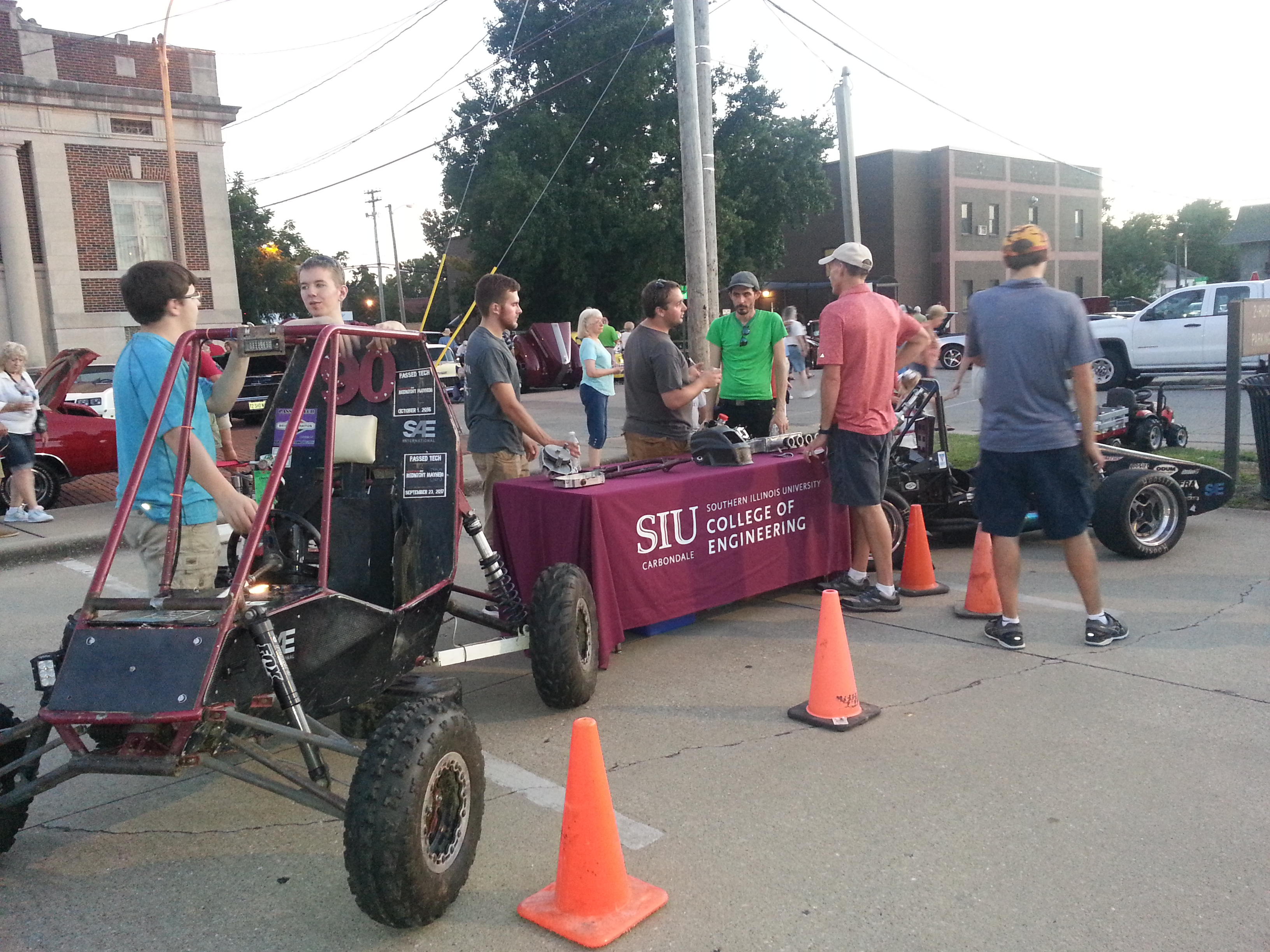 Students at table next to baja car