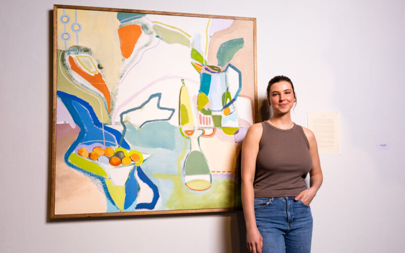 Emma Metz, a senior in painting, is shown with her oil and acrylic paintings that captured a share of the 2023 Rickert-Ziebold Trust Award.