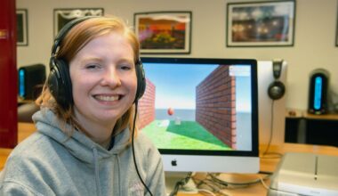 Anna Hainline, junior Animation student sitting in front of a computer that she is using for animation.