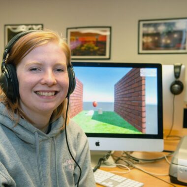 Anna Hainline, junior Animation student sitting in front of a computer that she is using for animation.