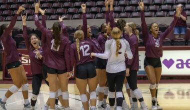 saluki volleyball team cheering after a game