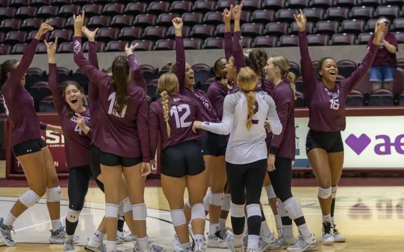 saluki volleyball team cheering after a game