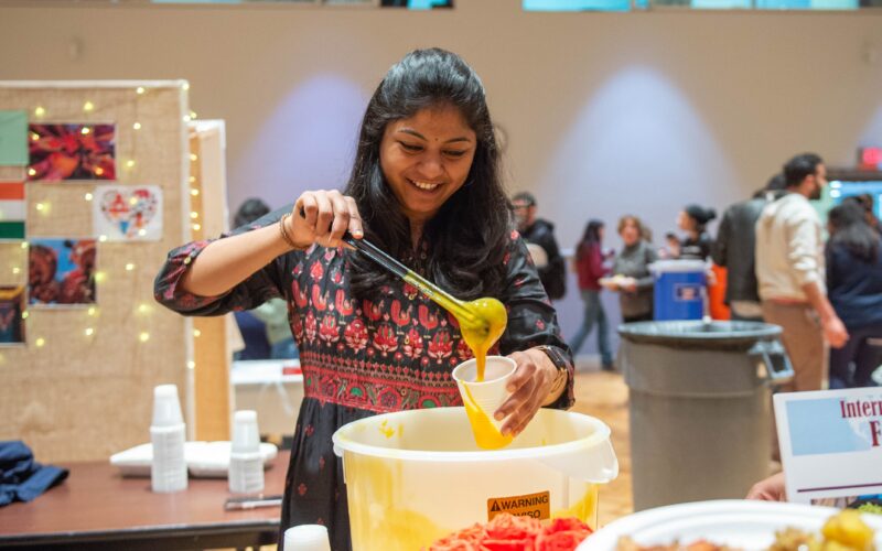 Indian student serving food at the International Food Fest.