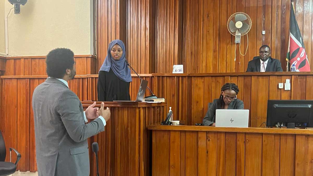 A group of students perform a mock trial while on a trip to Kenya.