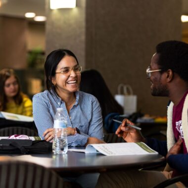 students talking to each other while studying