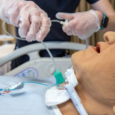 nursing student practicing on a doll