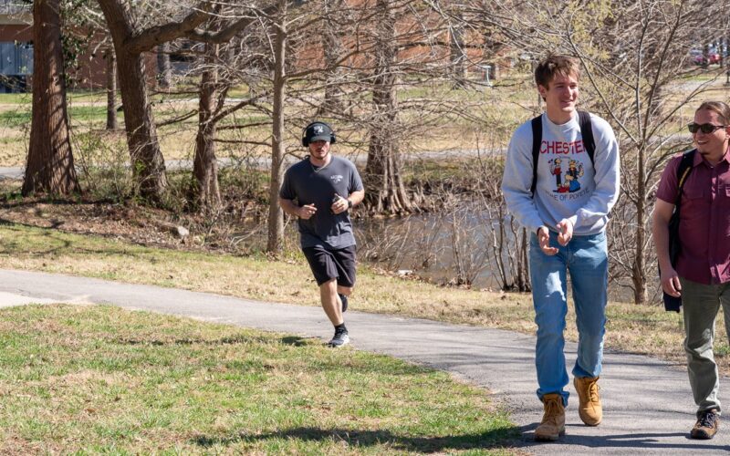 students walking at campus lake