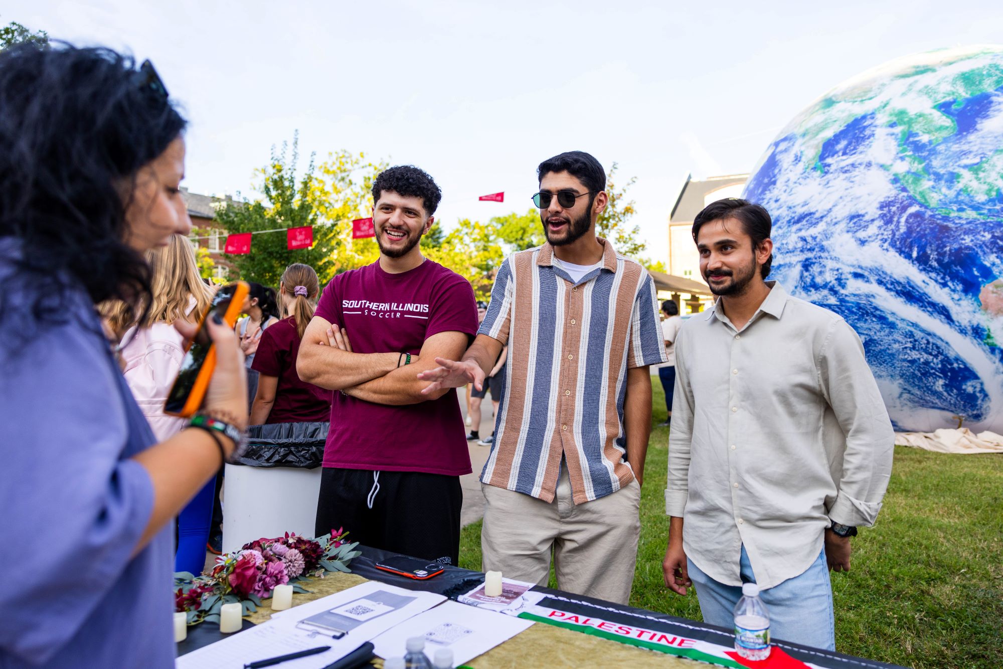 students speaking to a staff member at an RSO event