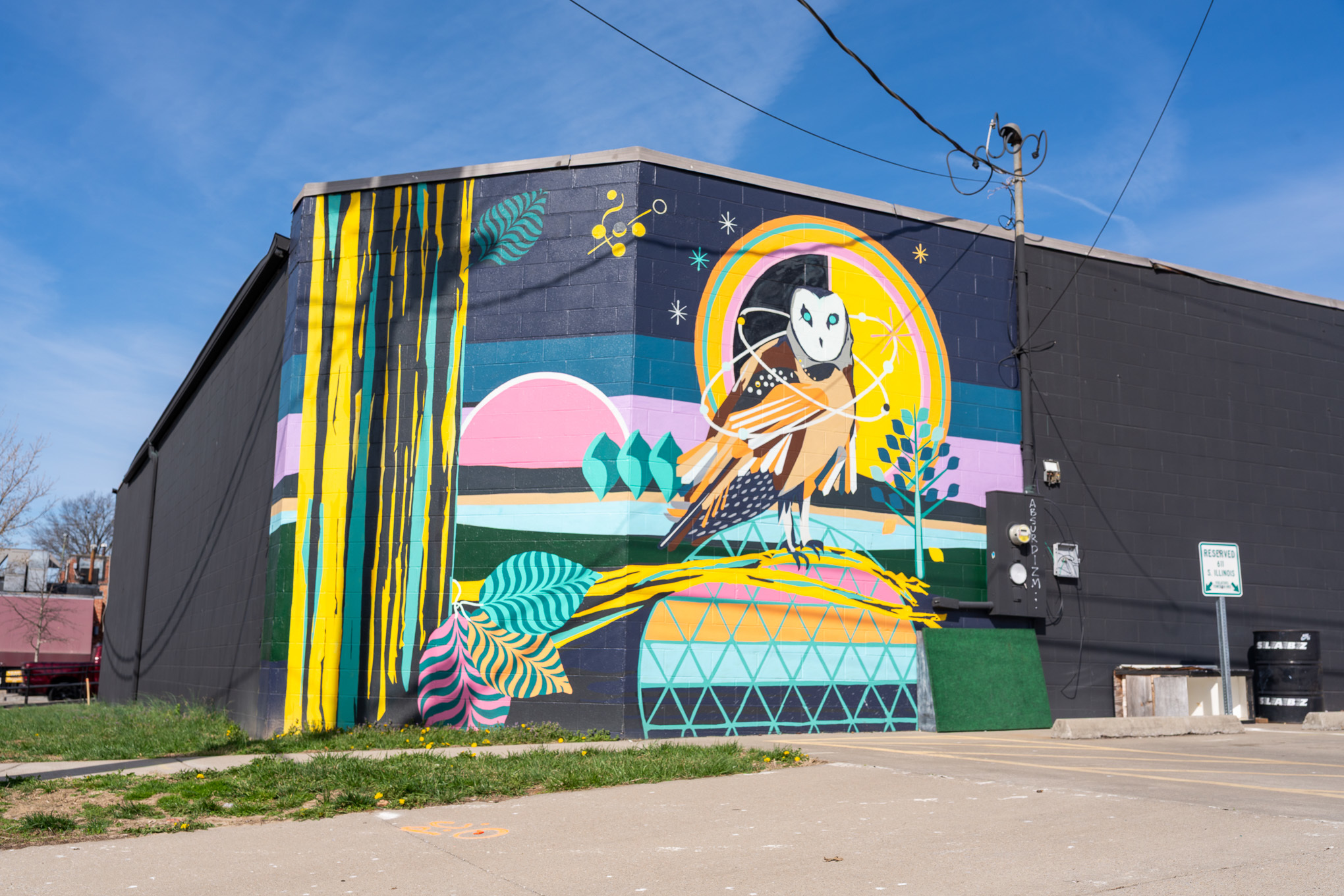 Mural of an owl with six orbs wrapped around it.