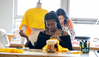 A student is sewing clothes.