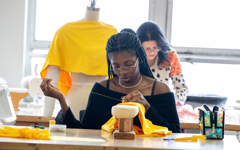 A student is sewing clothes.