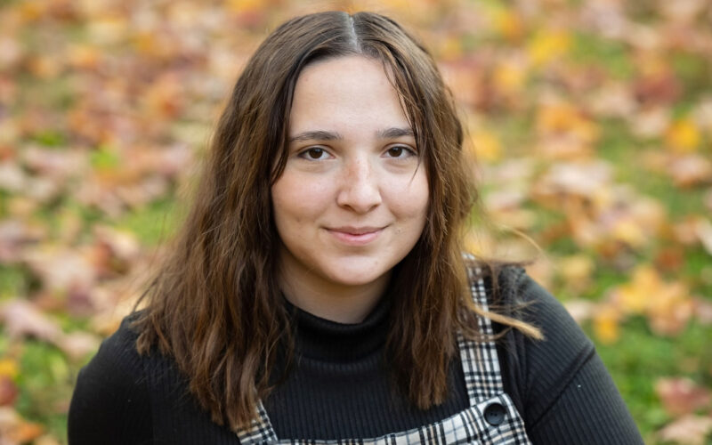 A young woman wearing a black shirt.