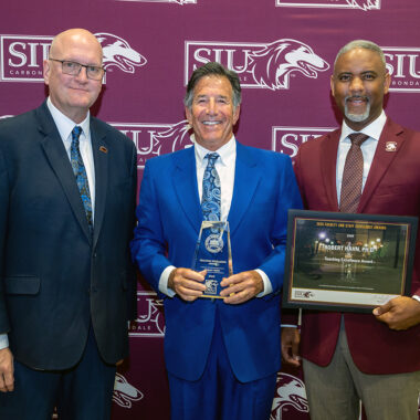 Robert Hahn (center) receives his Excellence Award from Joddy Murray, dean of the College of Liberal Arts (left) and Chancellor Austin Lane.