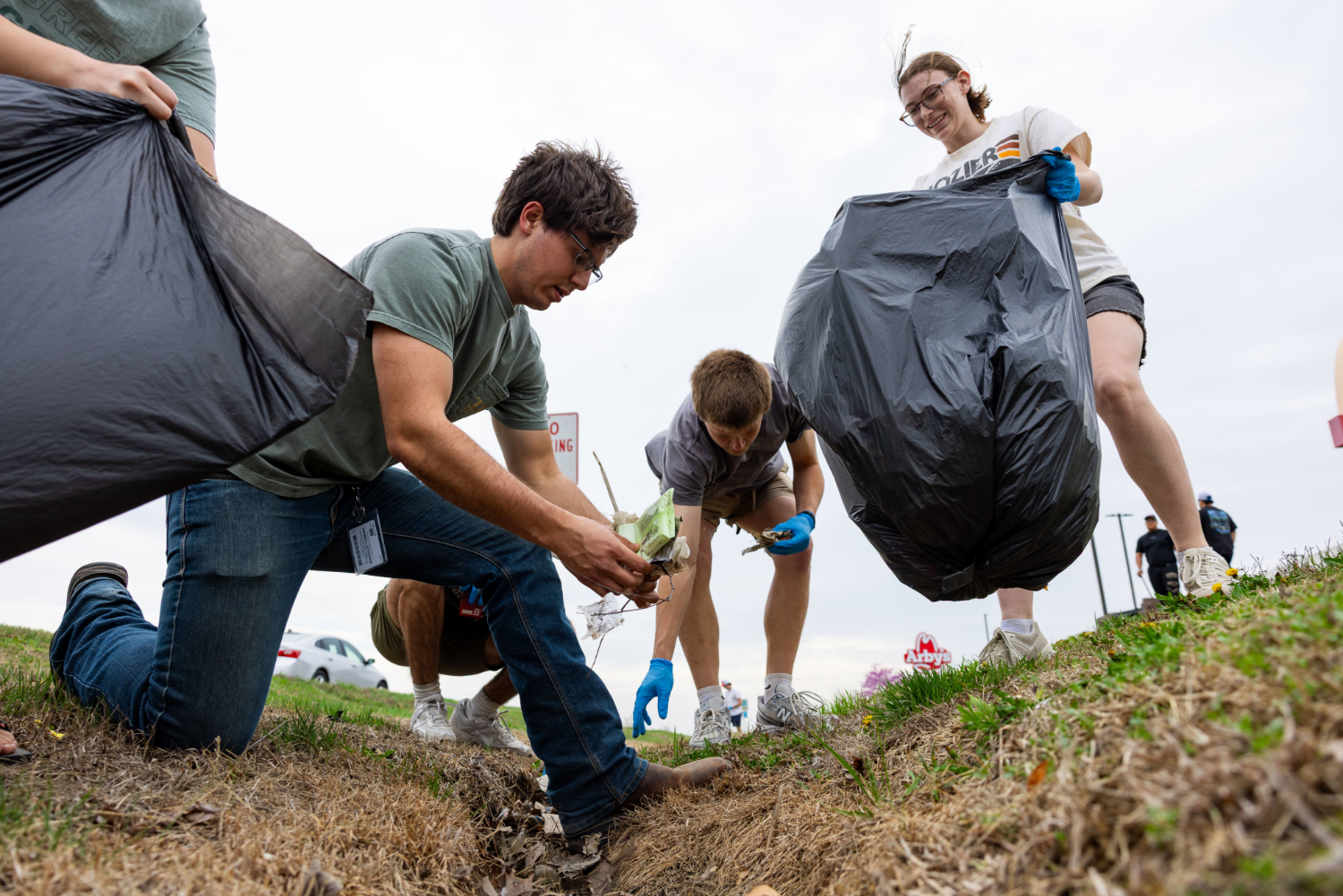 Greek Life members doing volunteer service work, planting trees. 