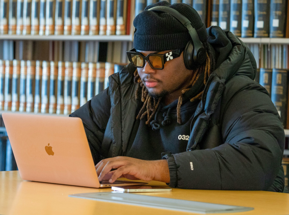 student studying on a laptop in the library
