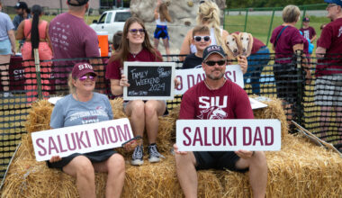 family posing for a photo at the family weekend football game