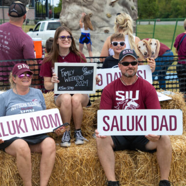 family posing for a photo at the family weekend football game