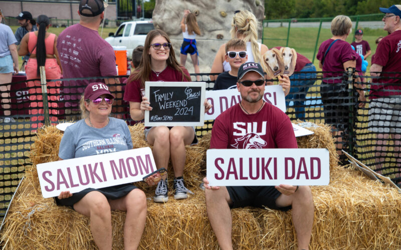 family posing for a photo at the family weekend football game