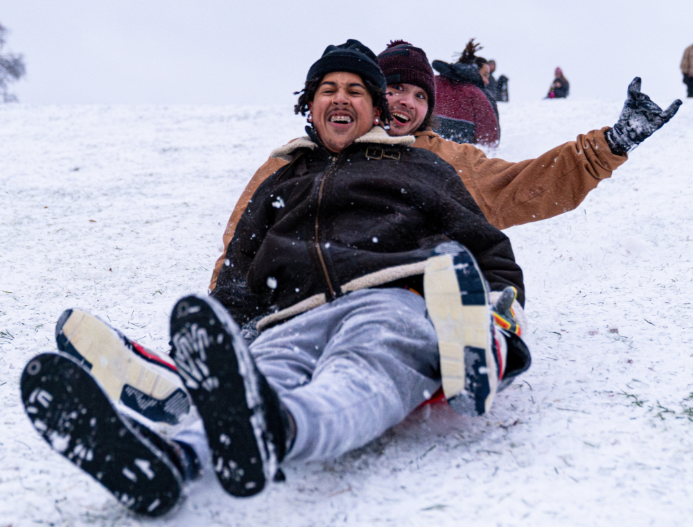 Students sledding down the hill at the Banterra Center.