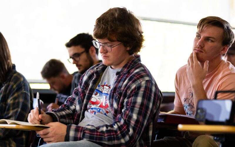 student taking notes in class