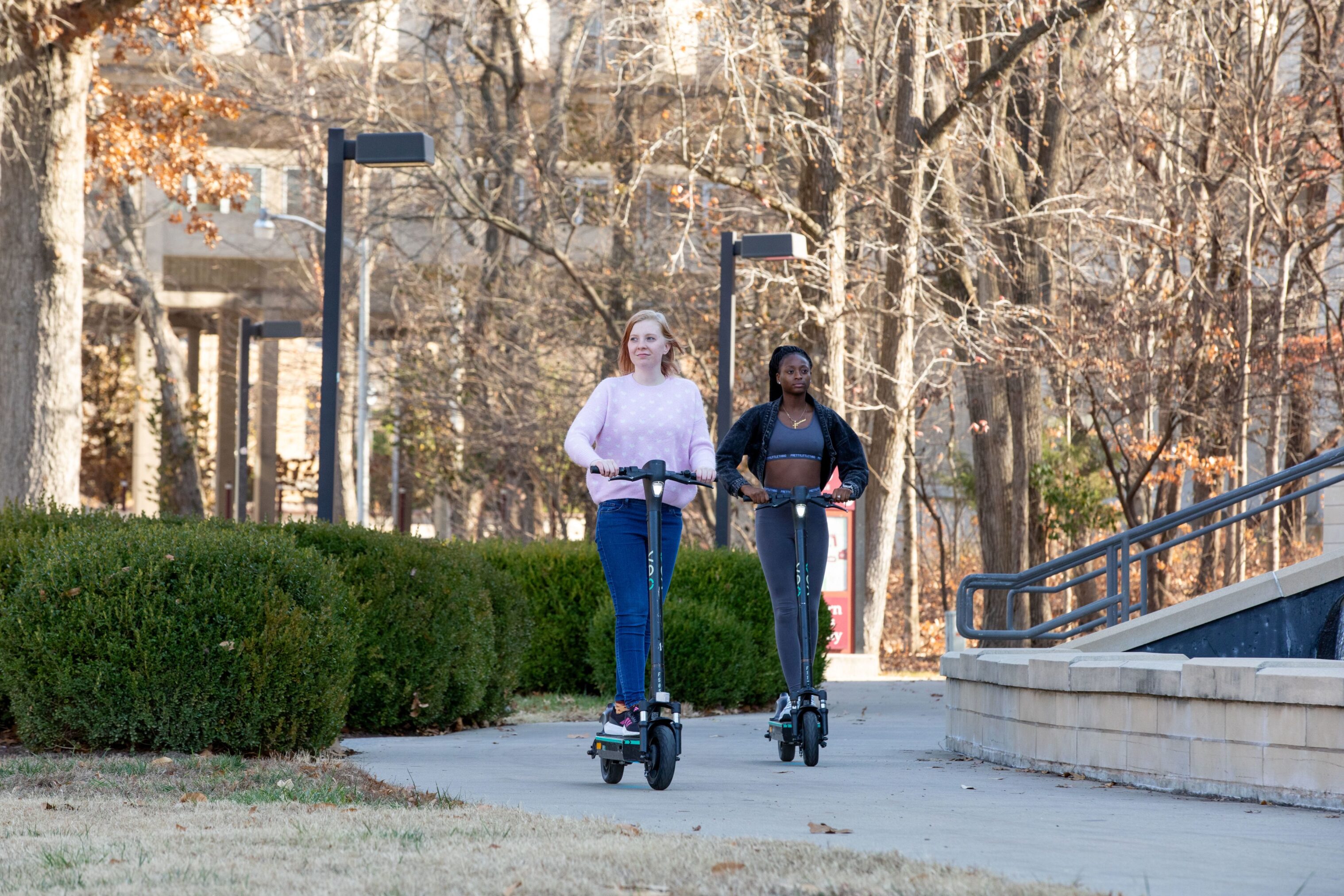 Students riding Veo scooters