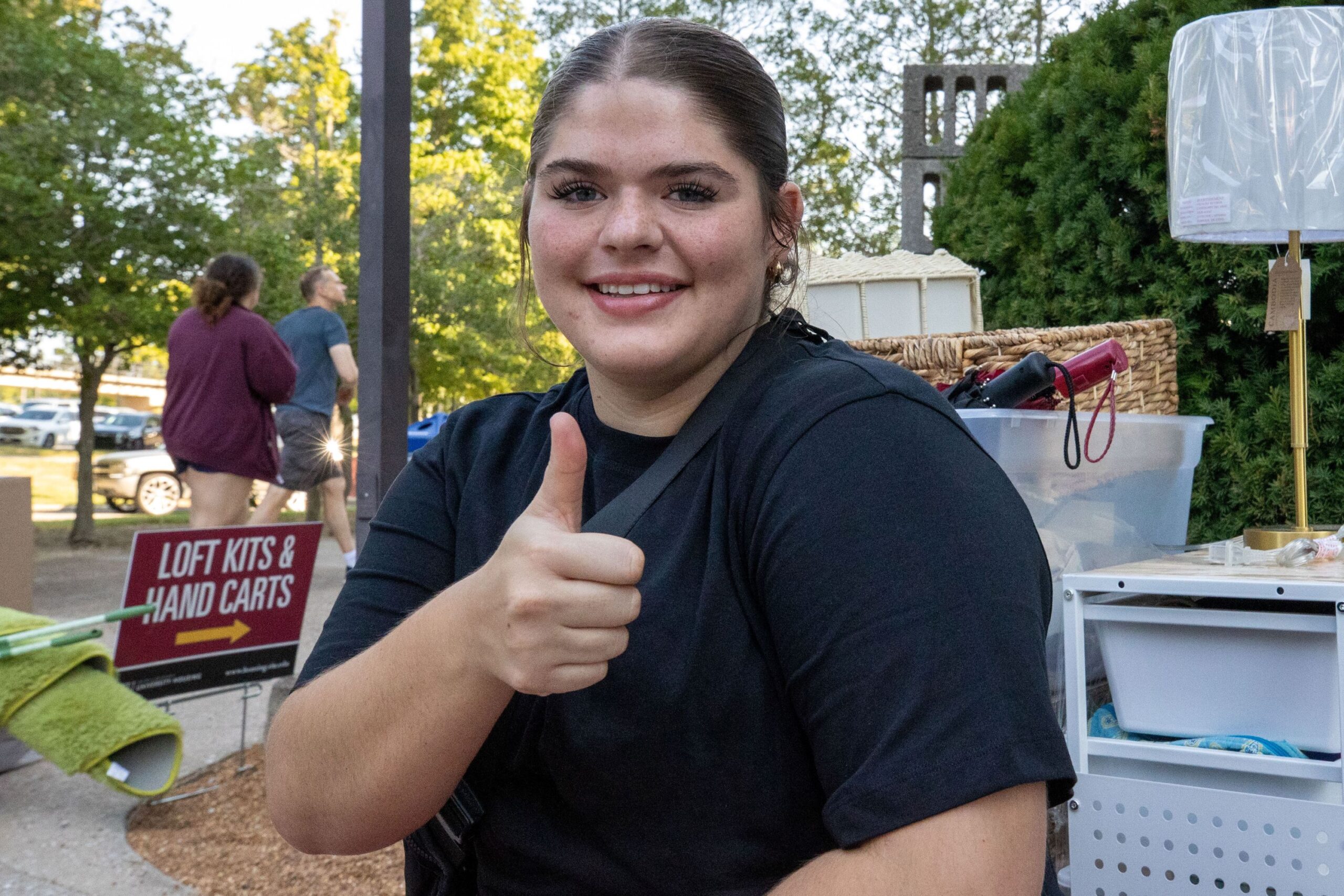 2025 Saluki Startup | New Student Move In person giving the camera a thumbs up while their belongings are behind them in the photo