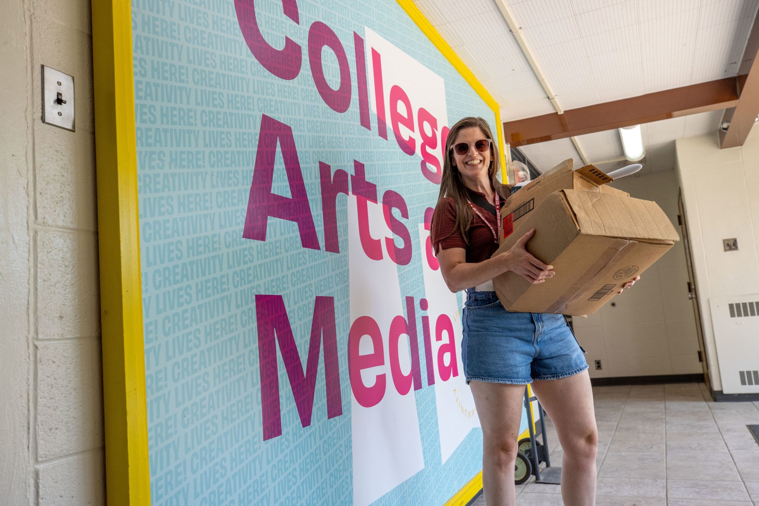 2025 Saluki Startup | New Student Move In person carrying boxes into residence halls