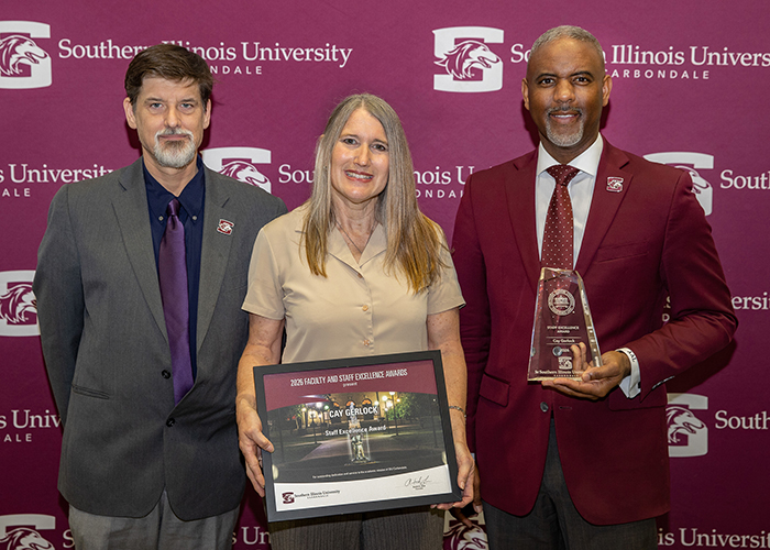 Cay Gerlock (center) receives the 2026 Excellence Award for Civil Service staff.