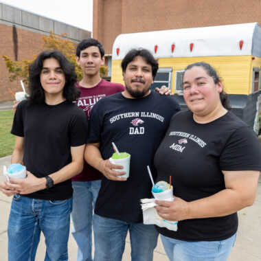 student with their family on campus