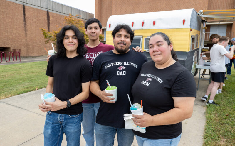 student with their family on campus