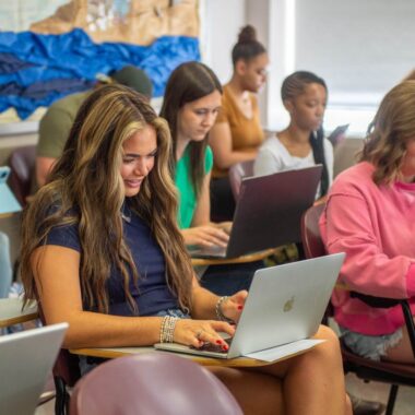 Students on laptops in class.