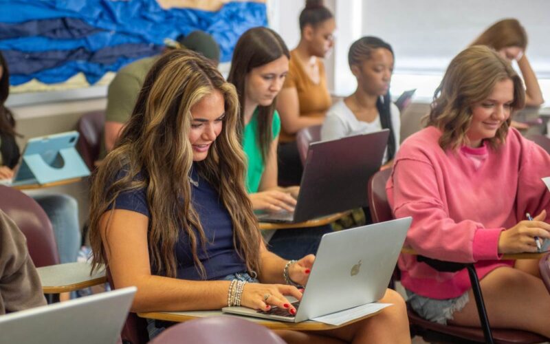 Students on laptops in class.