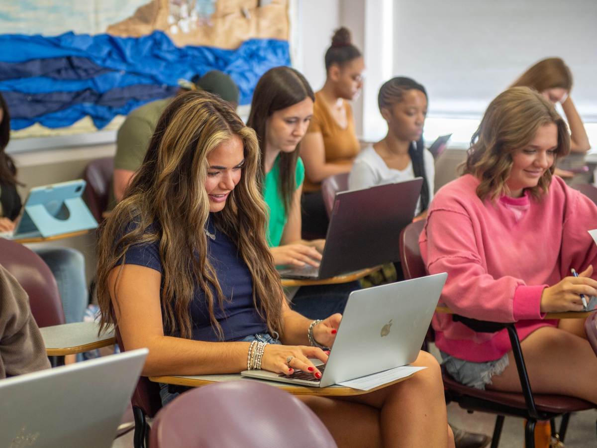 Students on laptops in class. 