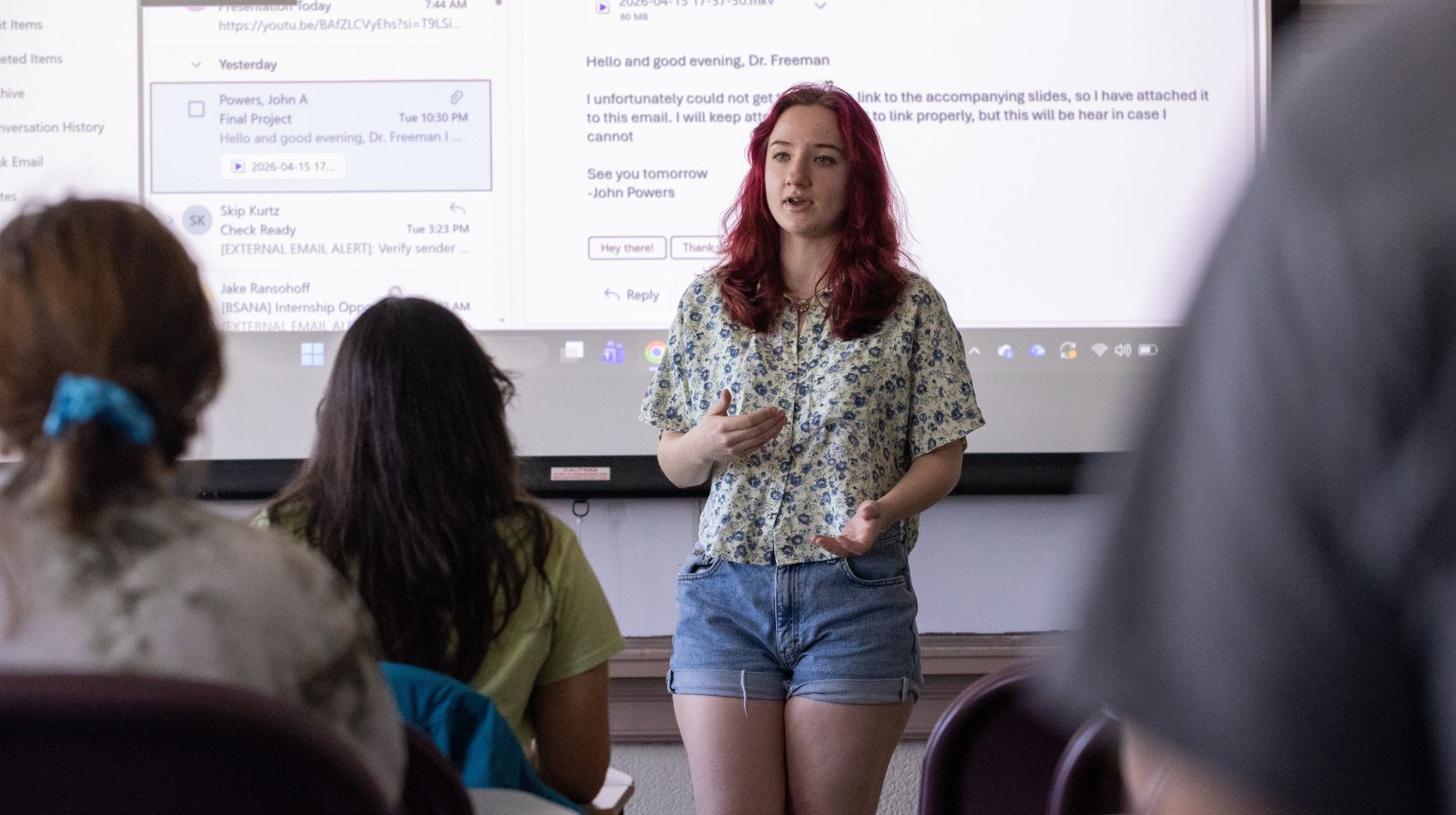 student giving a presentation to a full classroom

