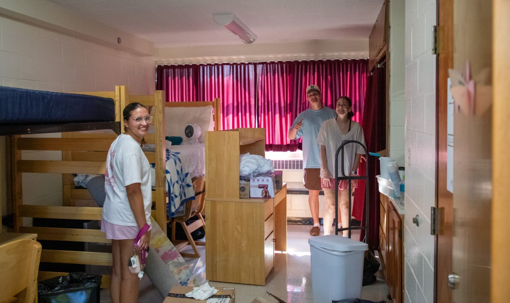 students with a residence hall room full of boxes

