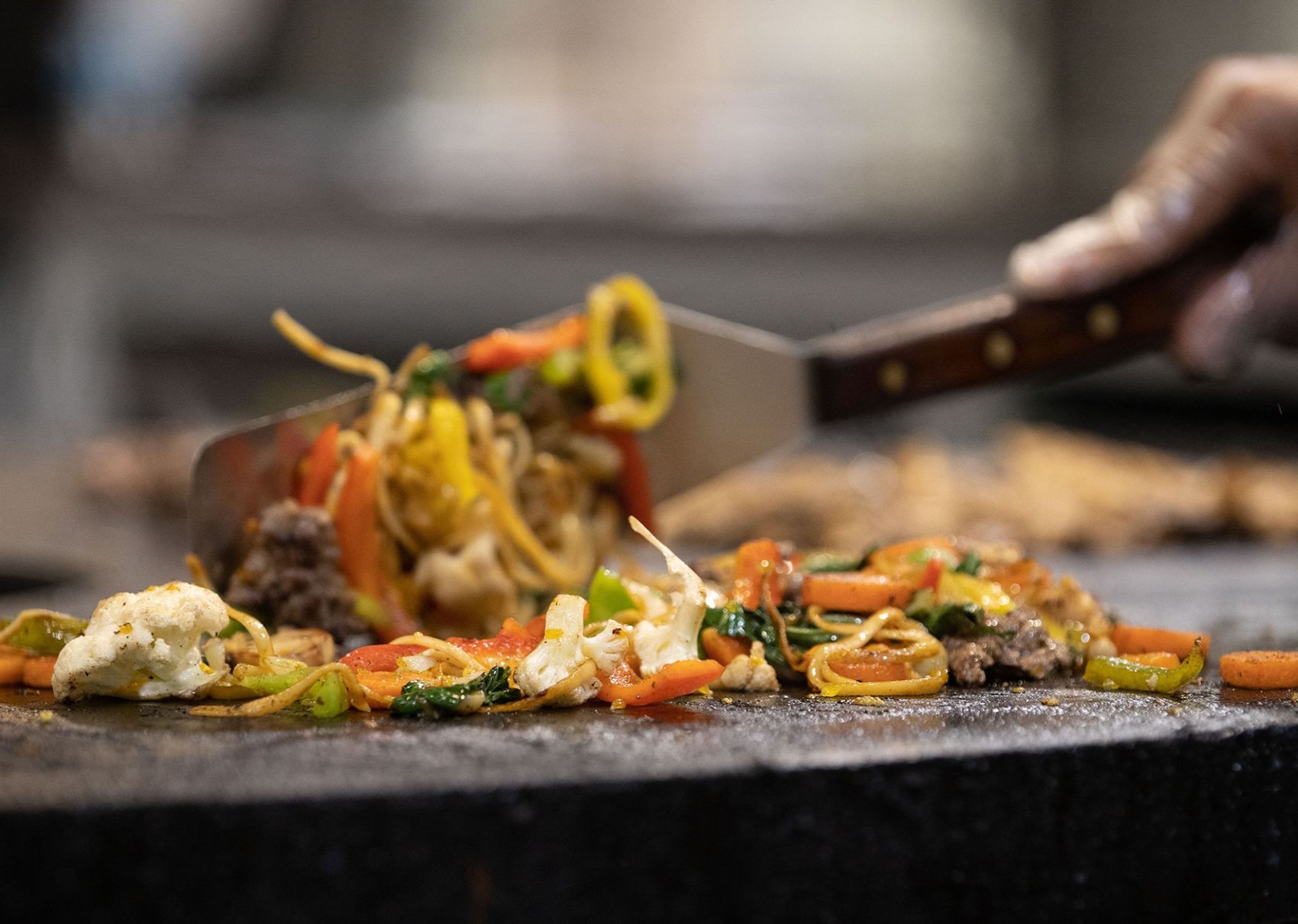 food being cooked on the mongolian grill
