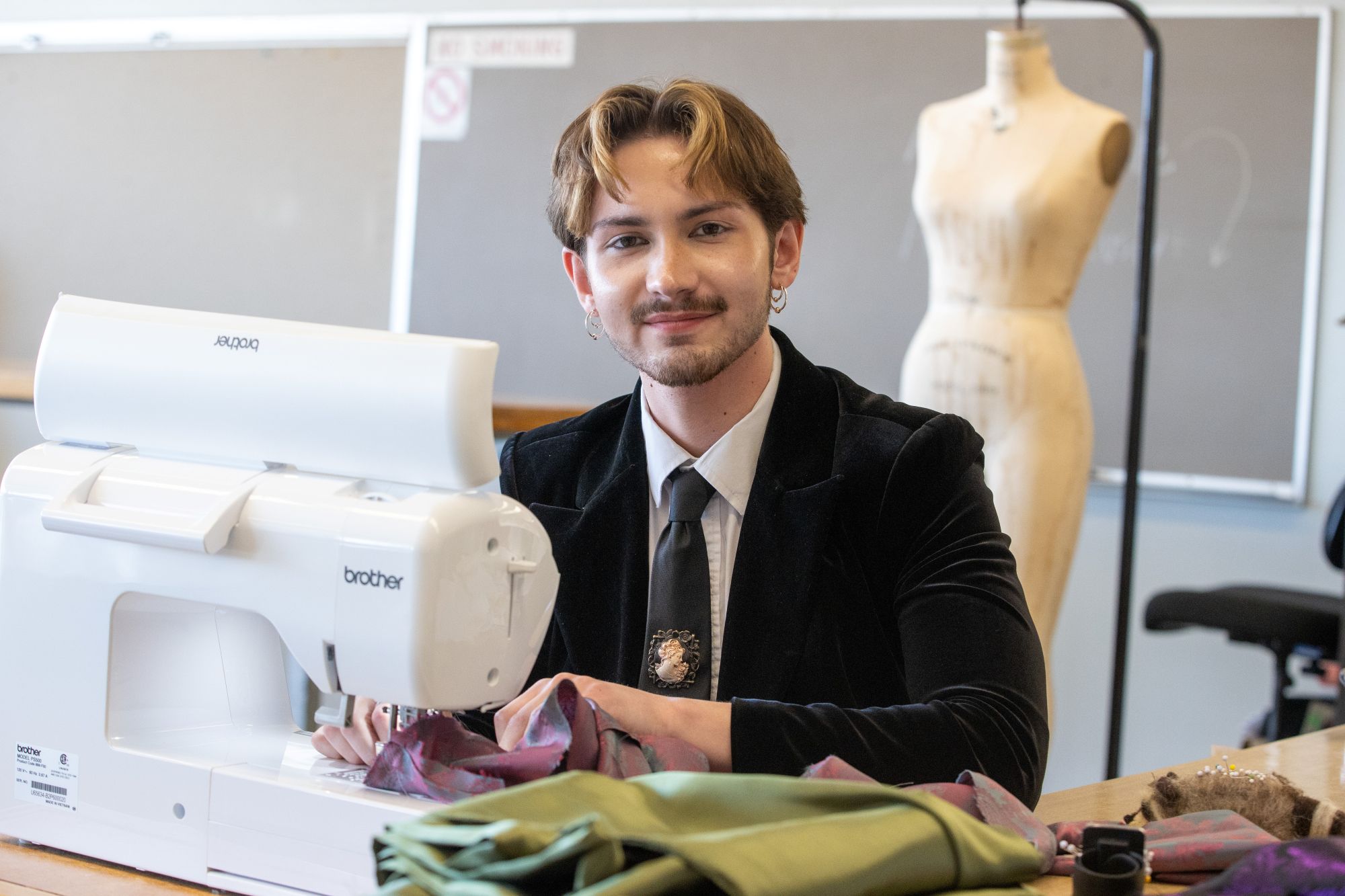 fashion design and merchandising student at sewing machine 